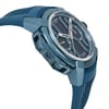 An image of a pre-owned wristwatch taken from a side profile view, opposite the crown. The watch features a blue case and strap with a textured design. The angle highlights the watch's sleek and modern design, with visible details on the dial, including markers and subdials, captured from a close distance.