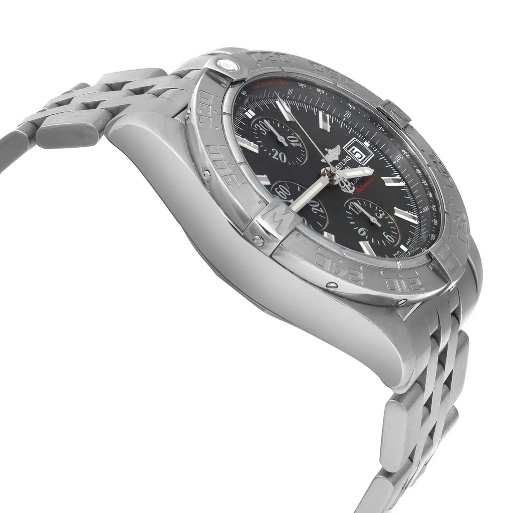 An image of a pre-owned Breitling men's wristwatch in a pilot/aviator style, captured from a side profile view opposite the crown. The watch has a round shape with a black dial and gray bezel, housed in a stainless steel case connected to a stainless steel band. The angle of the photo provides a clear view of the watch's side, showing minor patina on the hour markers and signs of wear indicative of its pre-owned condition. The image is taken at a close distance, emphasizing the watch's details and craftsmanship.