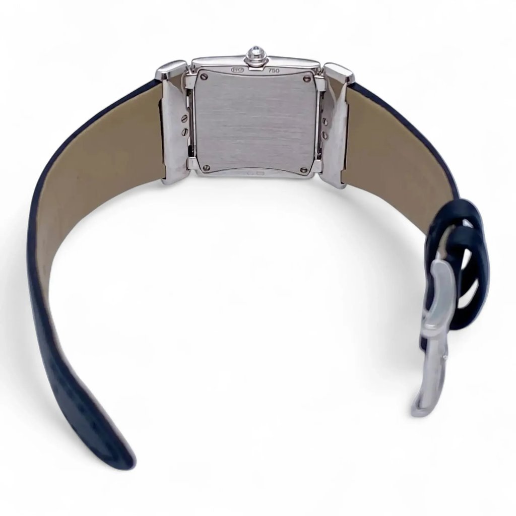 An image of a pre-owned Patek Philippe women's wristwatch viewed from the back. The watch is positioned upright with the case back and clasp visible, taken at a slight angle from above. The leather strap is partially unbuckled, and the image is captured from a medium distance.