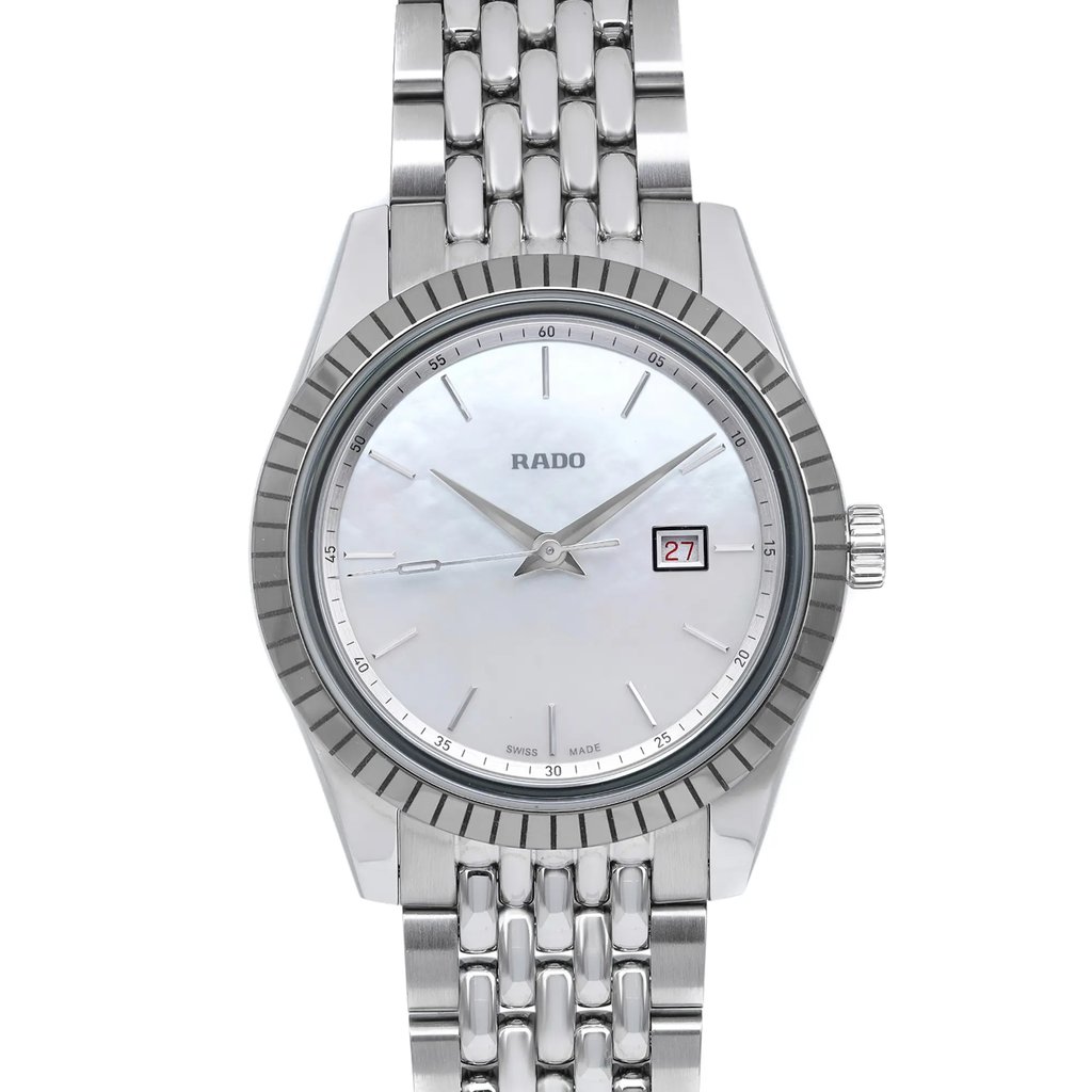 An image of a new, unworn Rado women's wristwatch with a dress/formal style. The watch is shown in a front close-up shot, capturing the entire round face and a portion of the stainless steel band. The white mother of pearl dial features stick indexes and a 12-hour layout with a stainless steel bezel. The Rado logo is visible at the top of the dial. The image is taken at a direct angle, emphasizing the watch's design and excellent condition.