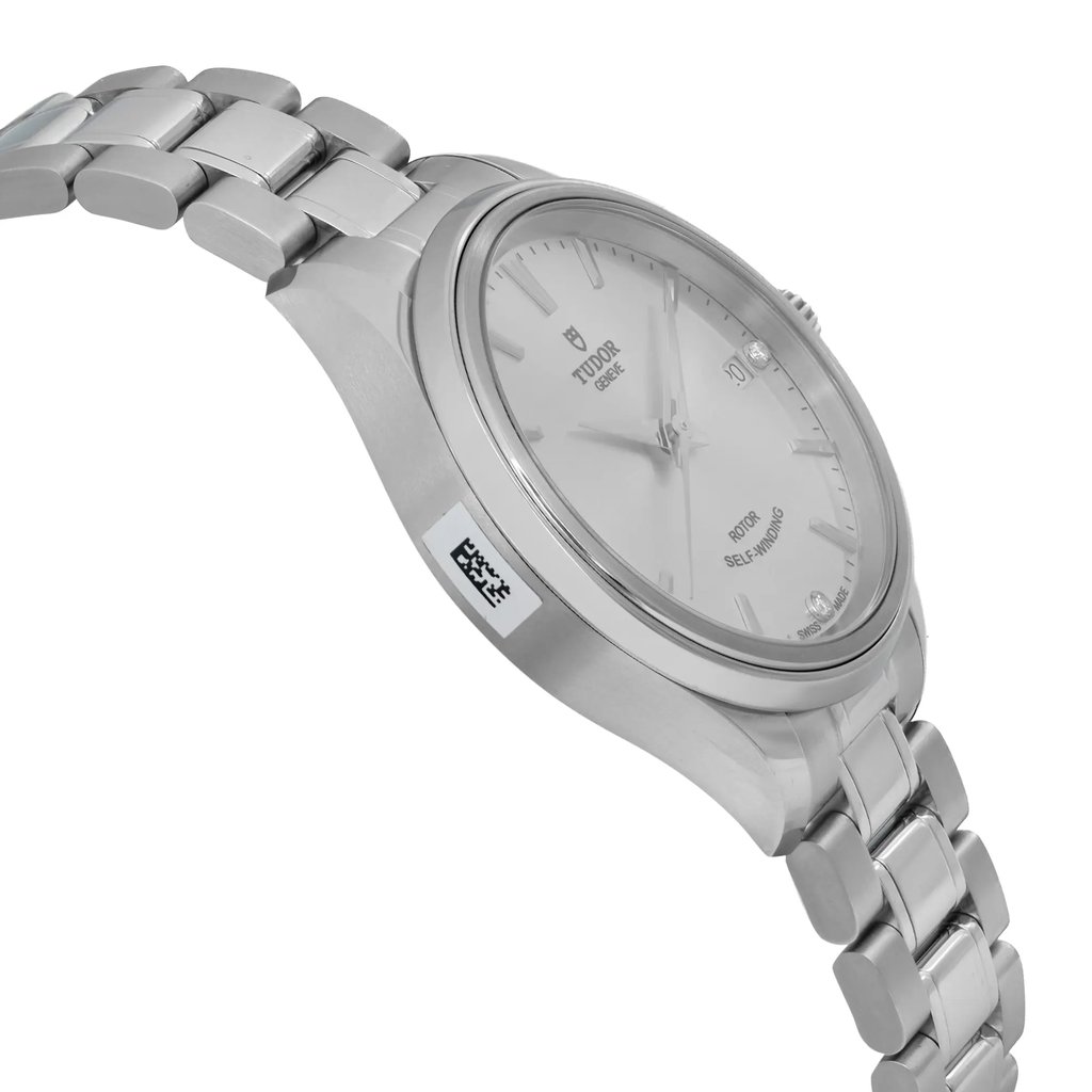 An image of a wristwatch shown from a side profile view, highlighting the opposite side of the crown. The watch is unworn and features a sleek, metallic band and casing. The angle captures the watch face from a slight upward perspective, emphasizing its smooth design and clear markings. The image is taken from a close distance, showcasing the watch's polished finish and intricate details.
