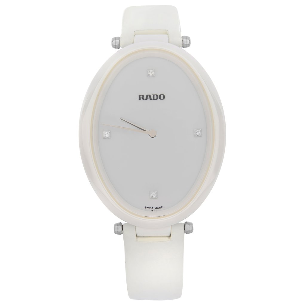 An image of a Wristwatch by Rado. This New With Defects item is designed for Women, featuring a Dress/Formal style. It has a Quartz movement and an Analog display with a White dial color. The indices include Diamonds, Unspecified. The band is made of Leather and the case is made of Ceramic. The watch has a Oval shape with a case size of 33 mm and a case thickness of 8.5 mm.