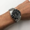 Up Close Front Facing Picture Of Rolex 114060 Stainless Steel Watch Pre Owned Condition