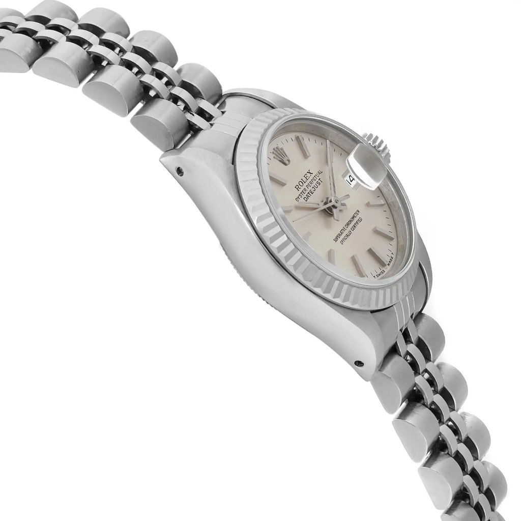 An image of a pre-owned wristwatch captured from a side profile view, opposite the crown. The watch is positioned at an angle, displaying the side of the case and part of the bracelet. The image is taken from a close distance, highlighting the details of the watch face and the links of the bracelet.