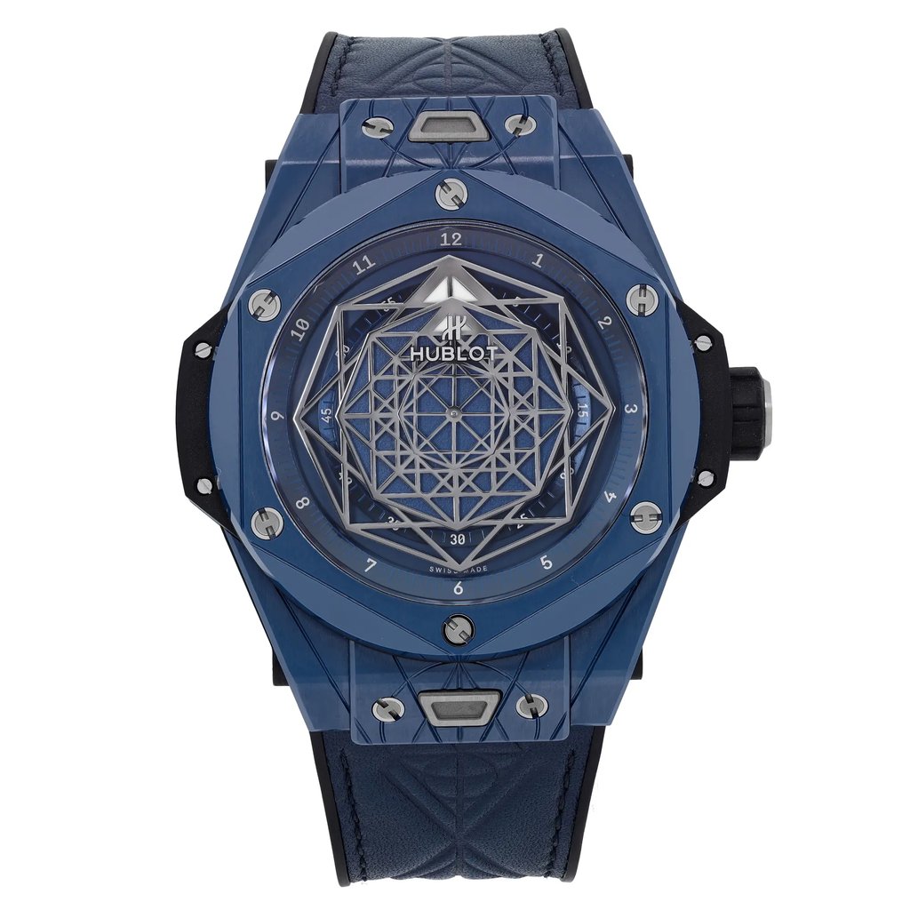 An image of a pre-owned wristwatch captured from a front full frontal view. The watch features a geometric patterned dial and a dark blue strap. The perspective is direct and close-up, highlighting the intricate design details and the overall condition of the timepiece.