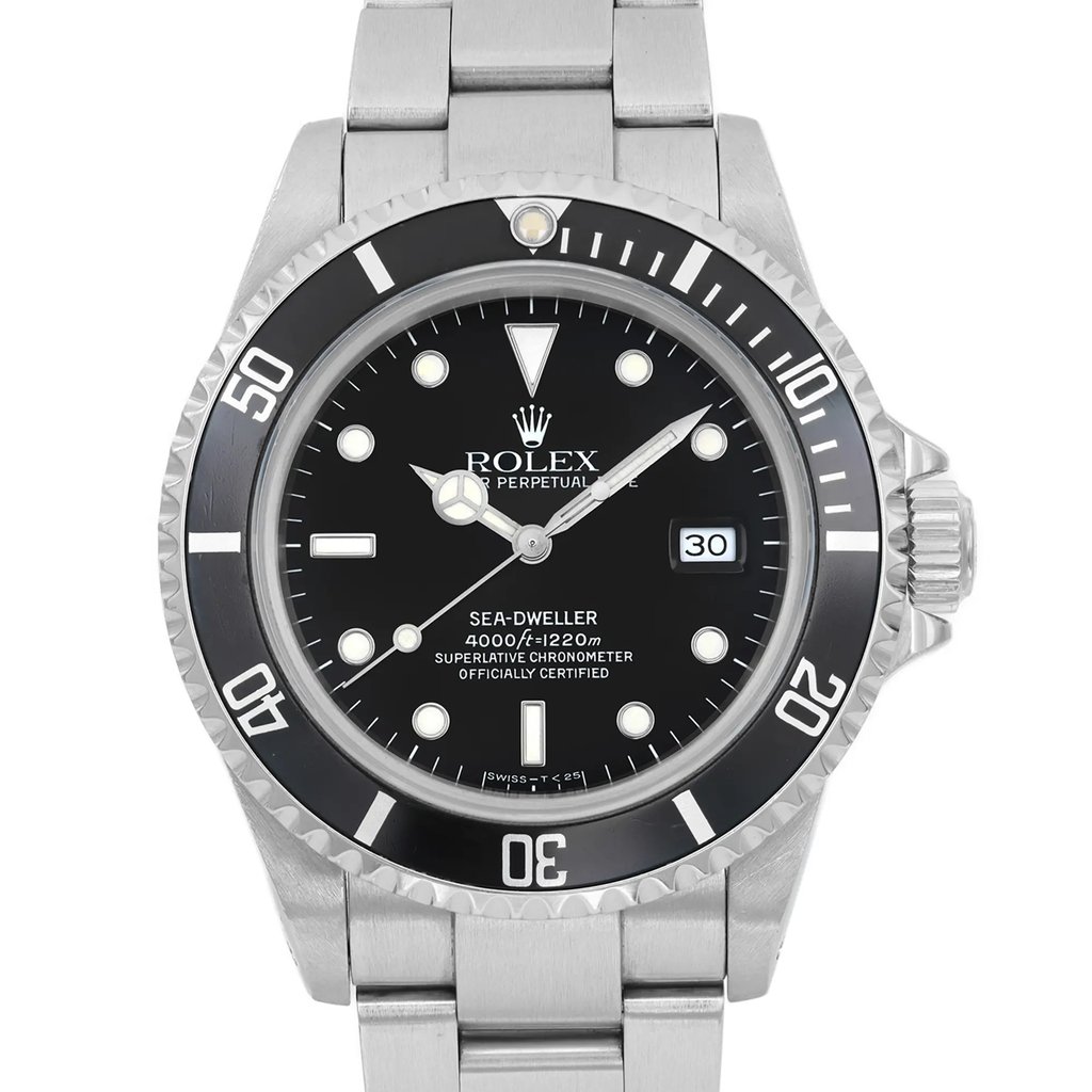 An image of a pre-owned men's Rolex diver wristwatch, viewed from the front in a close-up shot. The watch features a round black dial with round indexes and a date indicator. The bezel is black, and both the band and case are made of stainless steel. The watch is in good condition and includes luminous hands.