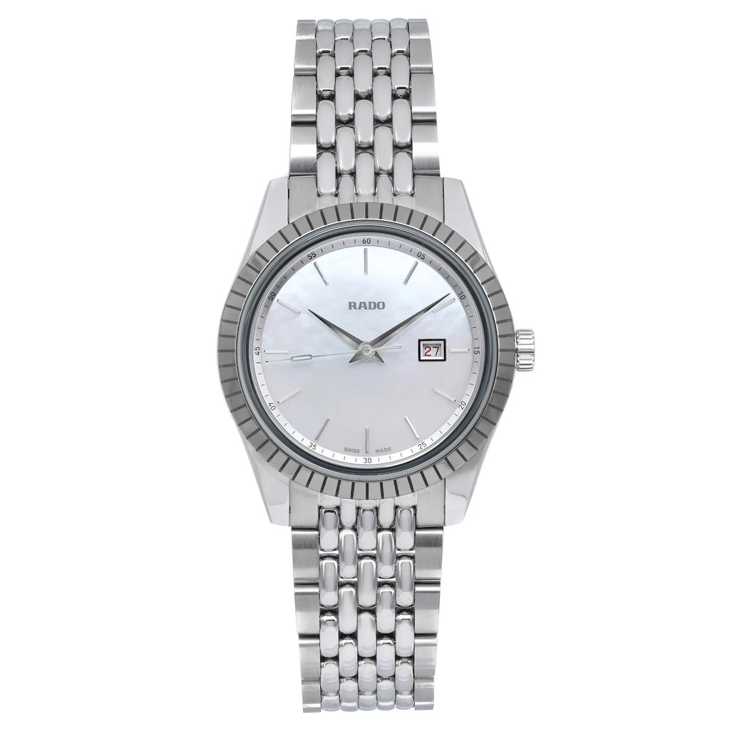 An image of an unworn Rado women's wristwatch in excellent condition, presented in a full frontal view. The watch features a round stainless steel case with a stainless steel bezel, a mother of pearl dial with stick indexes, and a 12-hour dial display with a date function at 3 o'clock. The stainless steel band complements the dress/formal style of the watch. The image is taken at a close distance, ensuring the watch fills the frame for a detailed view.