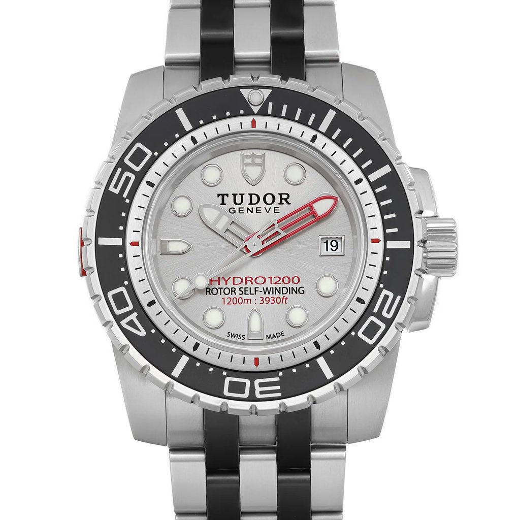 An image of a wristwatch taken from a front close-up angle, showcasing the watch face. The watch is new with defects and features a silver dial, luminescent markers, and a date display. The bezel is black with white numerals and markings, and the watch has a metal bracelet.