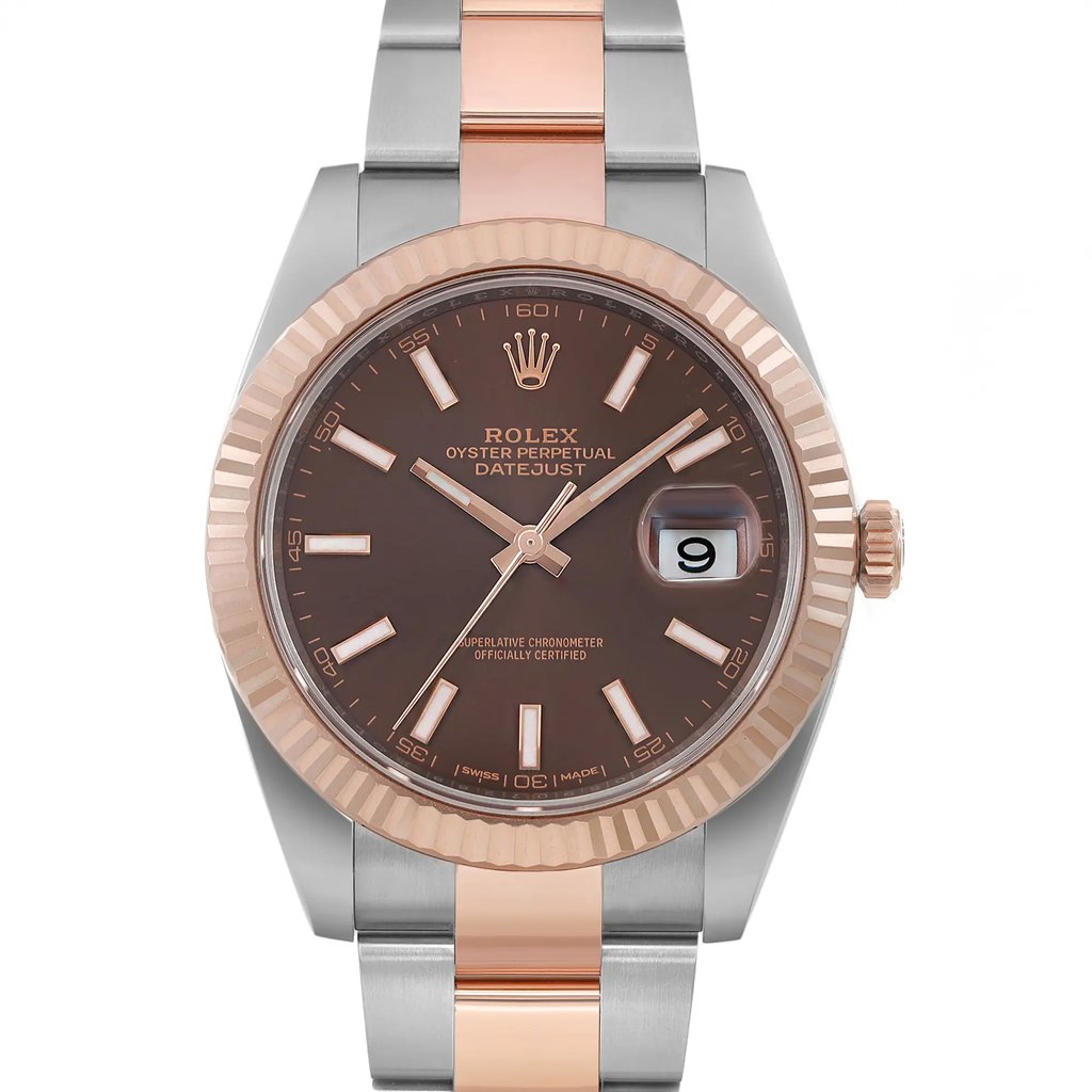 An image of a pre-owned Rolex men's wristwatch with a front close-up view of the round watch face. The dial is chocolate in color, featuring rose gold stick indices, luminous hands, and a date indicator at the 3 o'clock position. The bezel is rose gold, while the band is made of a combination of rose gold and stainless steel. The watch exhibits excellent condition with minor signs of wear and is at a close distance with the face positioned directly towards the camera. The watch shows minor signs of wear or scratches.