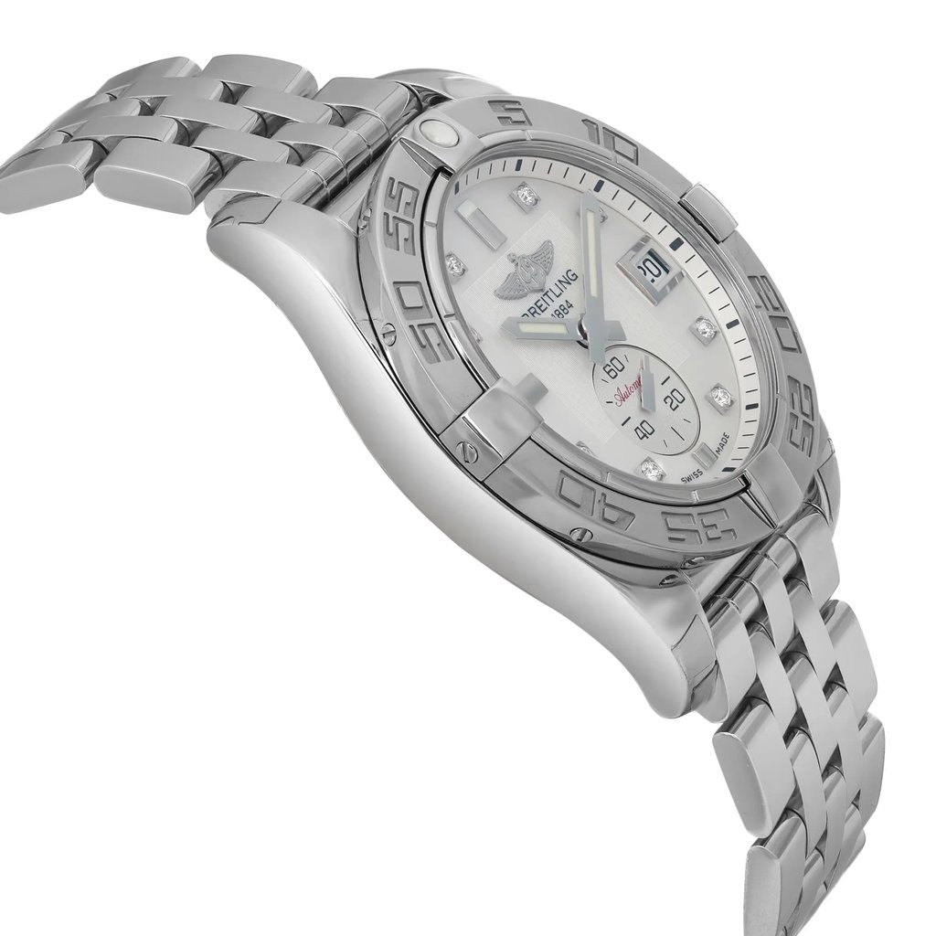 An image of a wristwatch taken from a side profile view, opposite the crown. The watch features a silver metallic bracelet and a detailed bezel with engraved numbers. The face is visible at a slight angle, displaying a clean design with a date window. The watch is positioned at a mid-range distance, showcasing its sleek and polished finish as a display model.