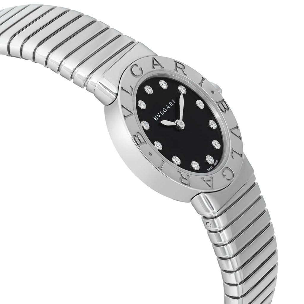 An image of a Bvlgari women's luxury wristwatch, displayed in a side profile view from the opposite side of the crown. The watch has a round shape with a black dial featuring a diamond pattern and sparkling hour markers. The bezel is gray, and the brand's name is engraved around it. The band is made of stainless steel with a horizontal striped pattern, and the case material is also stainless steel. The watch is positioned diagonally across the frame, with the dial closer to the viewer and the band extending into the background.