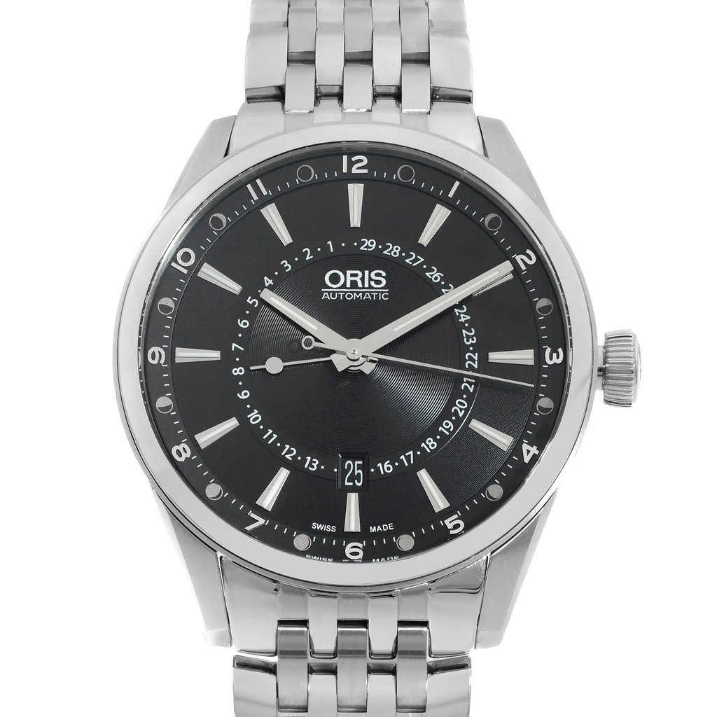 An image of a wristwatch taken from a front close-up angle, focusing on the watch face. The watch is a display model with a metallic bracelet and a black dial featuring silver-tone hour markers and hands. The brand name is visible on the dial, and the date is displayed at the 6 o'clock position. The crown is positioned on the right side of the watch face.
