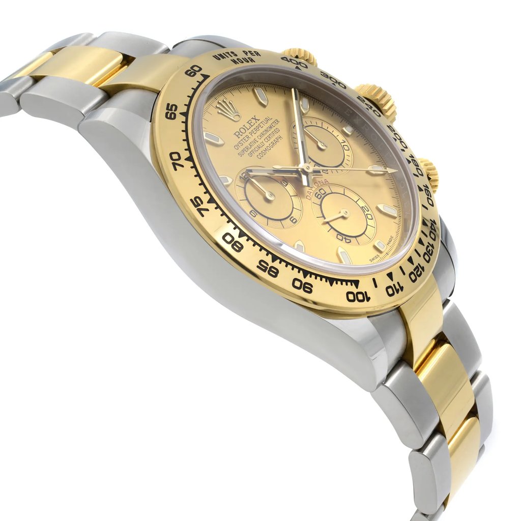 An image of a pre-owned men's Rolex luxury wristwatch. The watch is shown from a side profile view opposite the crown, positioned at a slight angle to highlight its features. The dial is champagne colored, complemented by a gold bezel. The band is a mix of stainless steel and yellow gold, and the case is stainless steel. The round watch face includes features such as a chronograph, luminous hands, and a small seconds subdial.