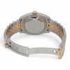 An image of a pre-owned Rolex wristwatch, viewed from the back at a slight angle. The watch is positioned centrally, showcasing its two-tone metal bracelet and closed clasp. The focus is on the back of the case, highlighting the crown at the top. The image is taken at a close distance, emphasizing the details of the bracelet links and clasp engraving.