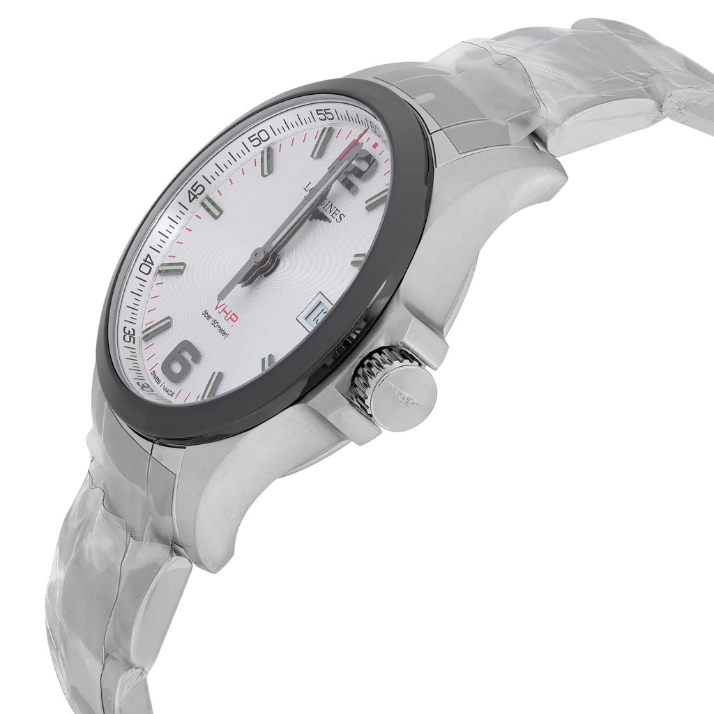 An image of a new wristwatch captured from a side profile view, highlighting the crown. The watch features a sleek, metallic band and a round face with a black bezel. The white dial displays dark hour markers and hands, with the brand logo visible. The angle showcases the design and details of the crown, emphasizing its polished finish.