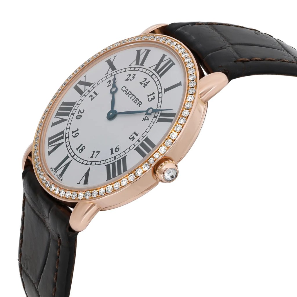 An image of a pre-owned wristwatch shown from a side profile view, highlighting the crown. The watch features a round face with Roman numerals, a diamond-studded bezel, and a black leather strap. The angle captures the elegant design details from a moderate distance, emphasizing the luxurious appearance.