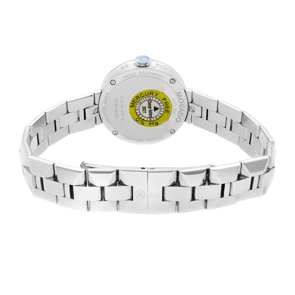 An image of a wristwatch taken from the back view, showcasing the closed clasp and bracelet links. The watch is positioned upright, with the face unseen, focusing on the metal band and the back of the watch case. The angle is straight on, and the distance is close, highlighting details like the "Mercury Free" label and inscriptions on the back. The watch is a display model in pristine condition.