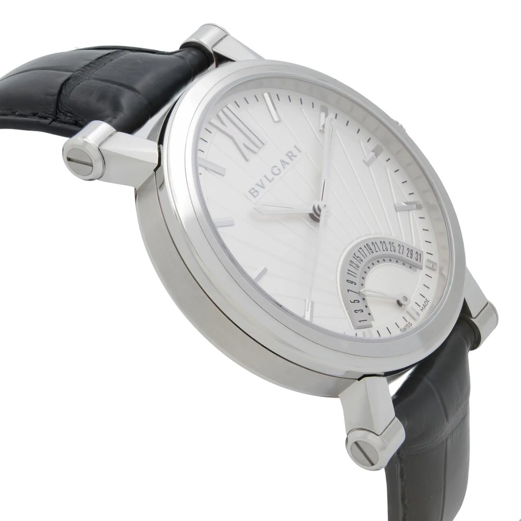 An image of a wristwatch viewed from the side profile, opposite the crown. The watch is a display model, showcasing a sleek silver case and a textured black leather strap. The angle highlights the watch's elegant design and detailing on the dial, viewed at a close distance to emphasize the craftsmanship.