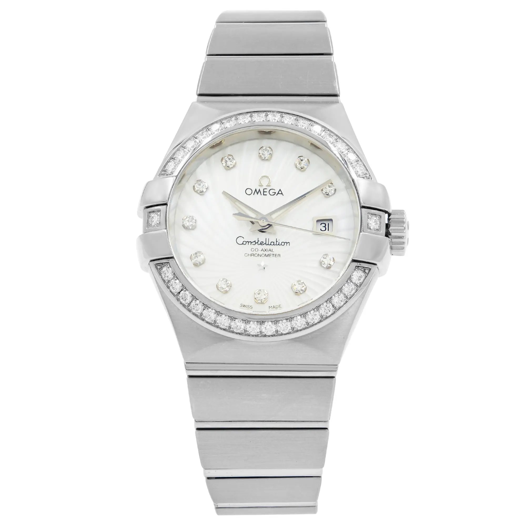 An image of a women's OMEGA Constellation wristwatch, displayed front-facing and centered at eye level. The watch features a white gold band and a round dial with diamond hour markers. The bezel is adorned with additional diamonds, and the date is visible at the 3 o'clock position. The watch is a display model, shown at a close-up angle to highlight its details.