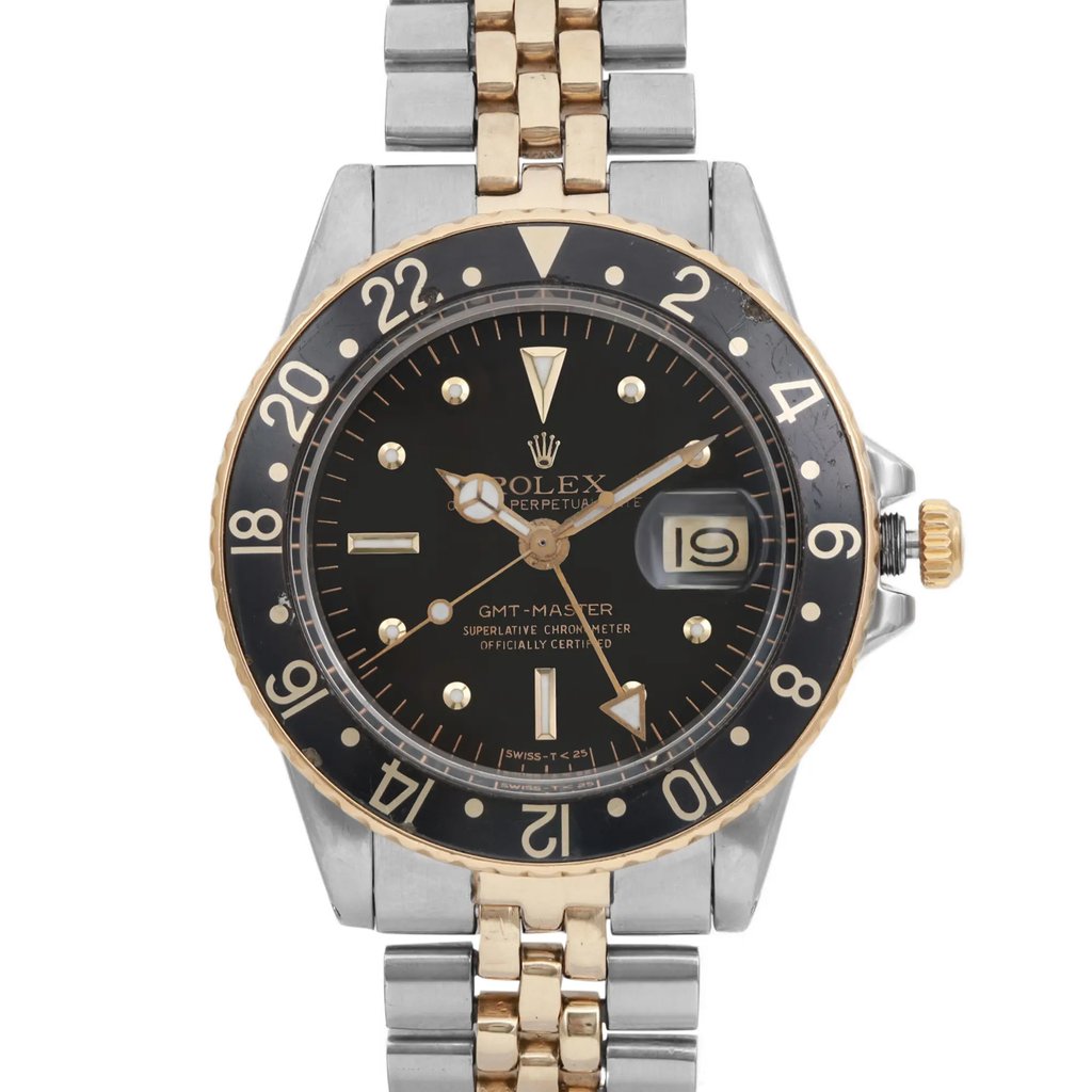 An image of a pre-owned wristwatch, featuring a close-up front view of the watch face. The watch has a black dial with gold accents and a date display on the right side. The bezel is gold with silver numbers, and the band is a combination of gold and silver links. The position is centered and the angle is straight-on, capturing the intricate details of the watch face and bracelet.