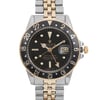 An image of a pre-owned wristwatch, featuring a close-up front view of the watch face. The watch has a black dial with gold accents and a date display on the right side. The bezel is gold with silver numbers, and the band is a combination of gold and silver links. The position is centered and the angle is straight-on, capturing the intricate details of the watch face and bracelet.