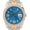 An image of a pre-owned unisex Rolex wristwatch taken from a front-facing angle. The watch features a blue dial with "Rolex" text pattern, gold hour markers, and a date indicator at the 3 o'clock position. The bezel is adorned with diamonds, and the watch case is two-tone, combining ssteel and gold elements. The image is captured at a close distance, highlighting the intricate details of the design.