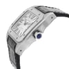 An image of a pre-owned Cartier men's wristwatch in a side profile view that highlights the crown. The watch has a square stainless steel case with a steel bezel and a white dial featuring luminous hands. It is styled with a classic black leather band and the crown is adorned with a blue cabochon. The watch embodies a casual, classic, dress/formal, and luxury style. The photograph is a close-up, showing the watch at a slight angle to emphasize the side profile and crown detail.