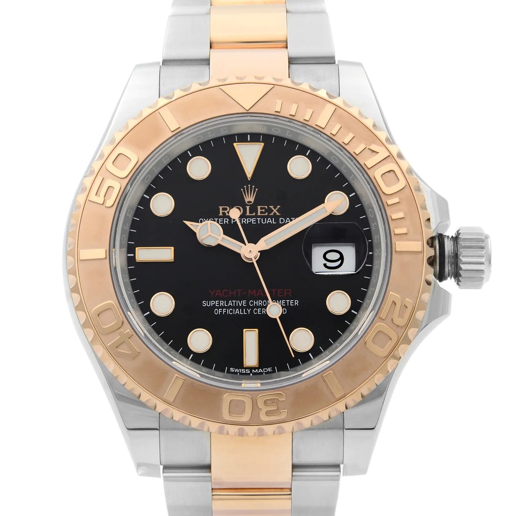 An image of a pre-owned wristwatch showing a front close-up shot of the watch face. The watch features a two-tone metal design with a gold bezel and a black dial. The brand name and various details are visible on the face, including a date window on the right side. The watch hands and hour markers are prominently displayed against the dark background.