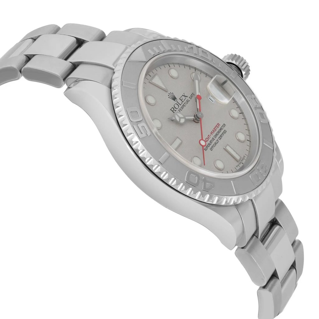 An image of a pre-owned wristwatch shown from a side profile view, opposite of the crown. The watch is positioned at an angle, highlighting its sleek metal bracelet and the textured edge of its bezel. The angle offers a clear view of the dial and the watch's overall design, captured from a close distance.