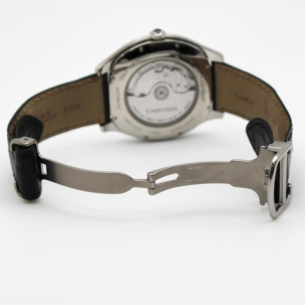 An image of a pre-owned Cartier men's wristwatch displayed from the back, showcasing its open clasp and the back of the watch face. The watch is positioned at a slight angle, with the focus on the intricate detailing of the movement visible through the transparent case back. The black leather strap is partially visible, and the image is taken from a close distance, emphasizing the craftsmanship and materials.
