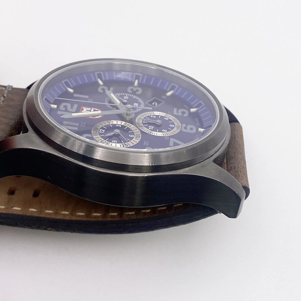 View of opposite crown facing side of the stainless steel case with a dents and scratches on it