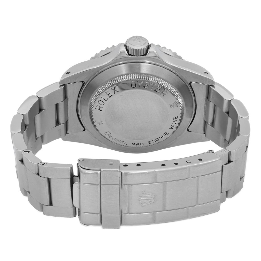 An image of a pre-owned men's Rolex wristwatch viewed from the back. The focus is on the stainless steel case and solid caseback, displaying engraved text. The stainless steel band features a double-locking fold-over clasp, with the Rolex logo visible. The angle captures a close-up of the clasp and back, showing the watch’s round shape and sturdy construction.