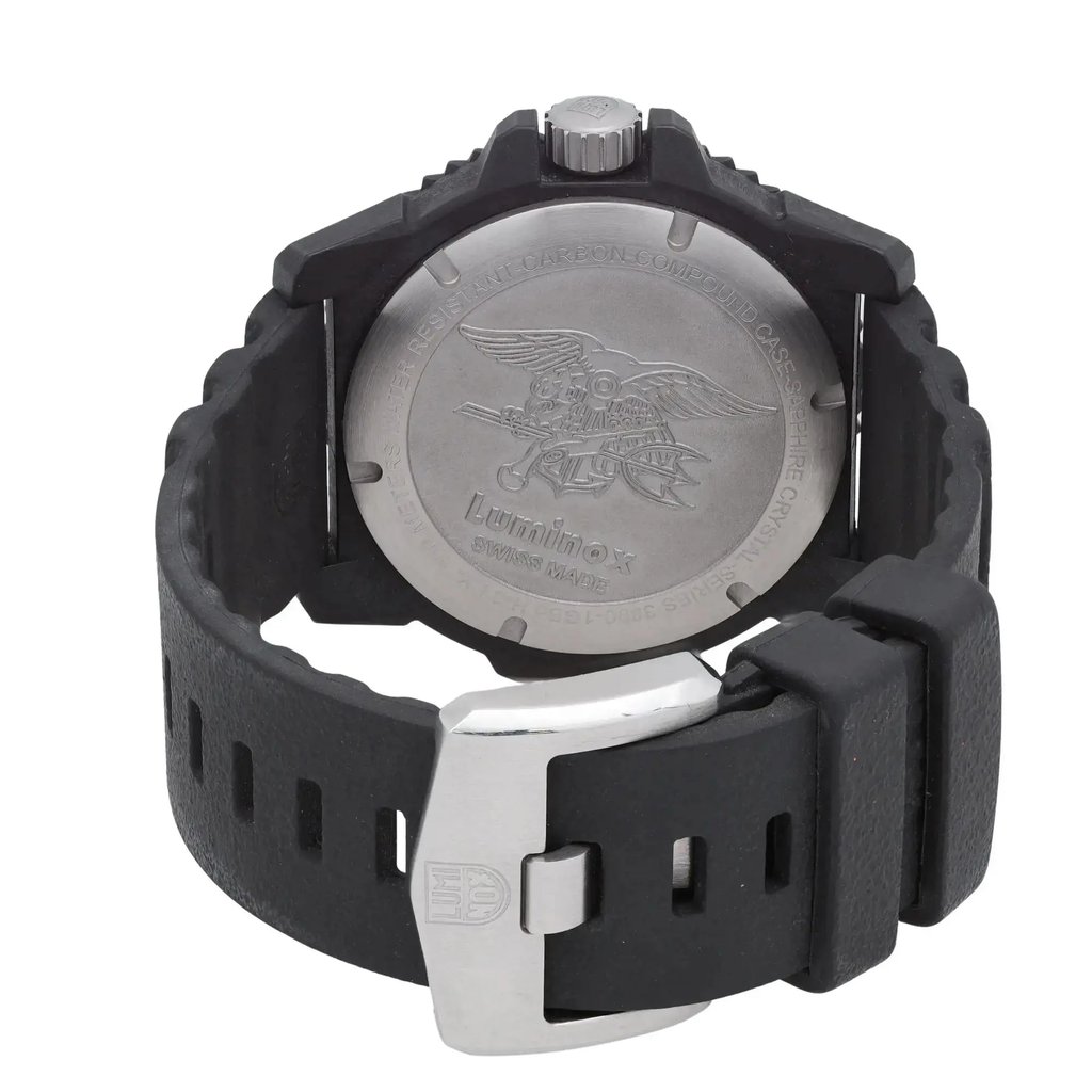 An image of a Wristwatch by Luminox. This Display Model item is designed for Men, featuring a Casual,Diver style. It has a Quartz movement and an Analog display with a Green dial color. The indices include 12-Hour Dial,Arabic Numerals,Easy to Read/Large Numerals. The band is made of Rubber and the case is made of Carbon. The watch has a Round shape with a case size of 46 mm and a case thickness of 14 mm.