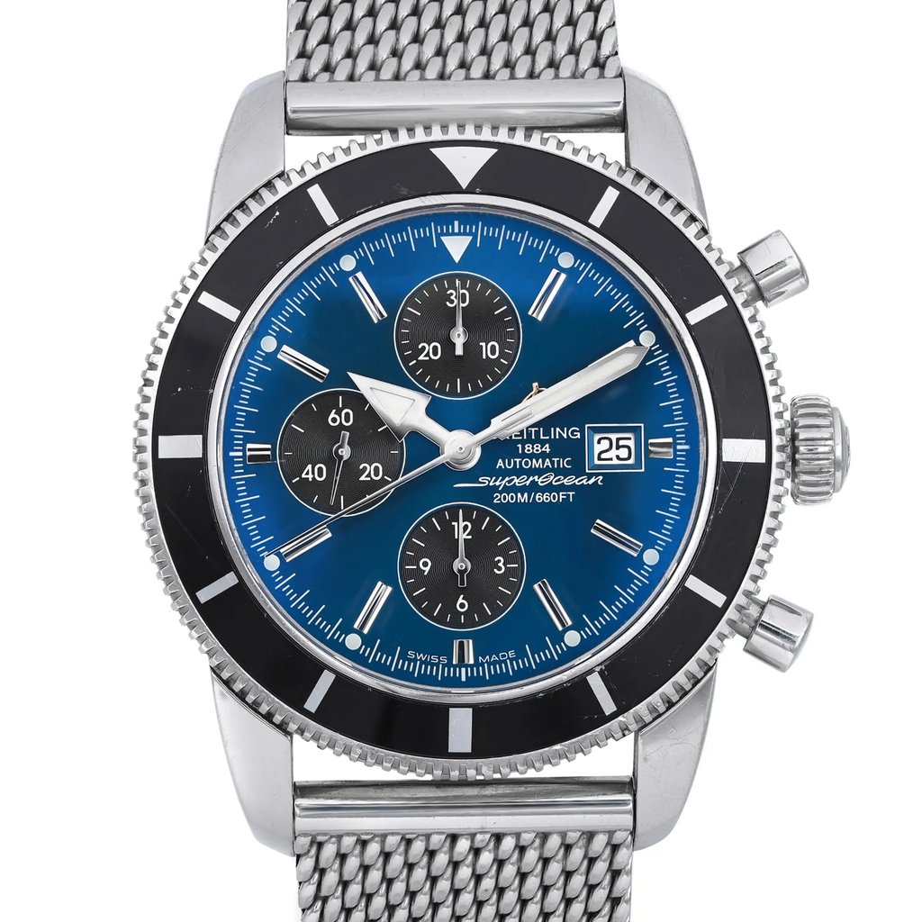 An image of a pre-owned Breitling men's wristwatch with a close-up front view focusing on the watch face. The watch features a round stainless steel case and a matching band, styled in a casual manner. It has a sunburst blue dial with gray stick indexes for the hours and a date indicator at the 3 o'clock position. Three subdials for the chronograph function are visible, and the hands are luminous. A black bezel with visible scratches on the insert surrounds the dial, and the watch has minor nicks on the case and case back. The angle of the photo is head-on, capturing the entire front of the watch with the band partially visible, and is taken from a close distance to show detail. The watch is in fair condition.