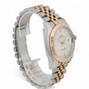 An image of a pre-owned men's Rolex wristwatch, viewed from a slightly angled side perspective at a medium distance. The watch features a two-tone band with stainless steel and gold links and a gold bezel. The dial is silver with luminous hands and a date indicator on the right side.