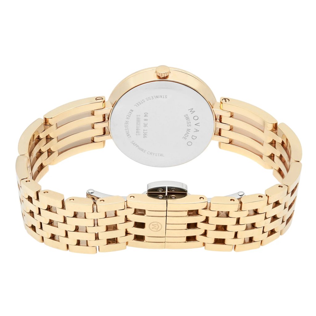 An image of a pre-owned wristwatch viewed from the back, showcasing the closed clasp. The angle captures the stainless steel case back and the gold-toned bracelet, displaying the brand's engraving. The shot is taken at a close distance, highlighting the intricate design of the metal links and the clasp mechanism.