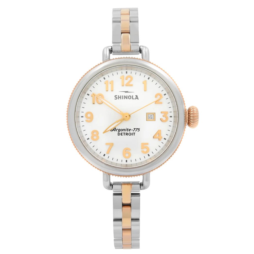 An image of a Wristwatch by Shinola. This Pre Owned item is designed for Women, featuring a Casual,Dress/Formal style. It has a Quartz movement and an Analog display with a White dial color. The indices include 12-Hour Dial,Arabic Numerals. The band is made of Stainless Steel and the case is made of Stainless Steel. The watch has a Round shape with a case size of 34 mm and a case thickness of 9 mm.