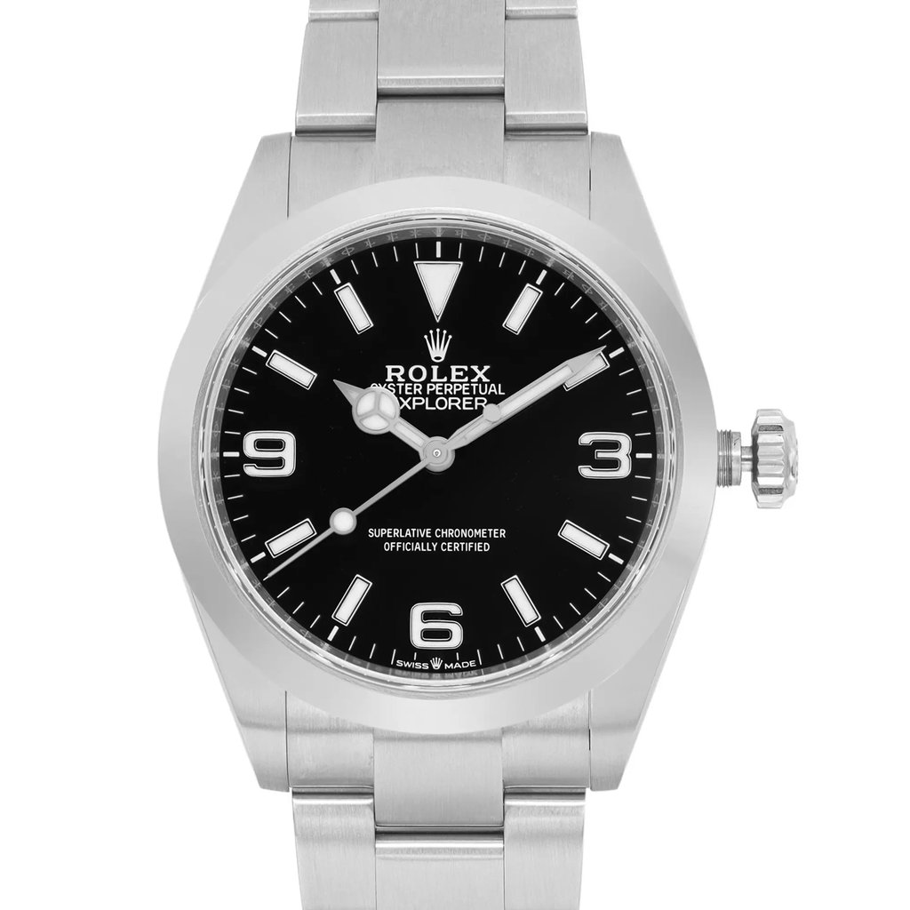 An image of a luxury men's wristwatch in excellent condition, viewed from the front in a close-up shot. The watch has a round black dial with Arabic numerals and luminous hands. The bezel is gray, and both the band and case are made of stainless steel. The watch is a new Rolex without tags.