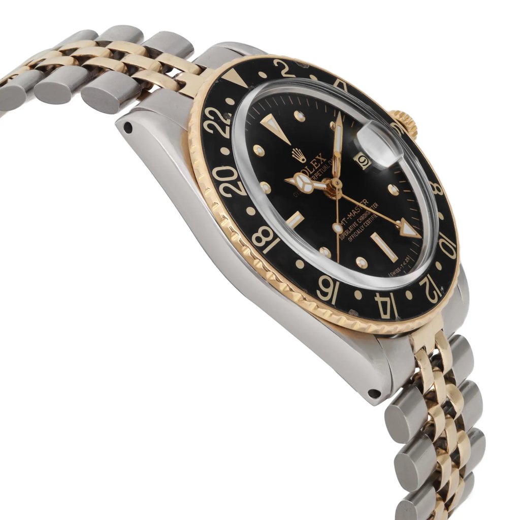 An image of a pre-owned wristwatch captured from the side profile view, opposite the crown, at a slight angle. The watch showcases a two-tone metal bracelet and a black dial with gold accents, including a numbered bezel. The angle highlights the watch's thickness and detailed craftsmanship.
