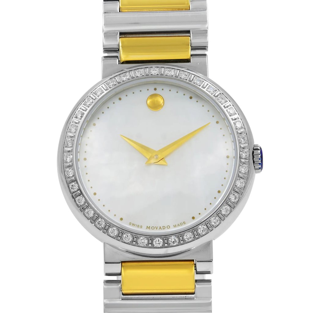 An image of a pre-owned wristwatch taken from a front close-up angle, focusing on the watch face. The watch has a minimalist design with gold hands, a circular gold marker at the 12 o'clock position, and a mother-of-pearl dial. The bezel is adorned with small gemstones, and the watch features a two-tone metal bracelet with gold accents.