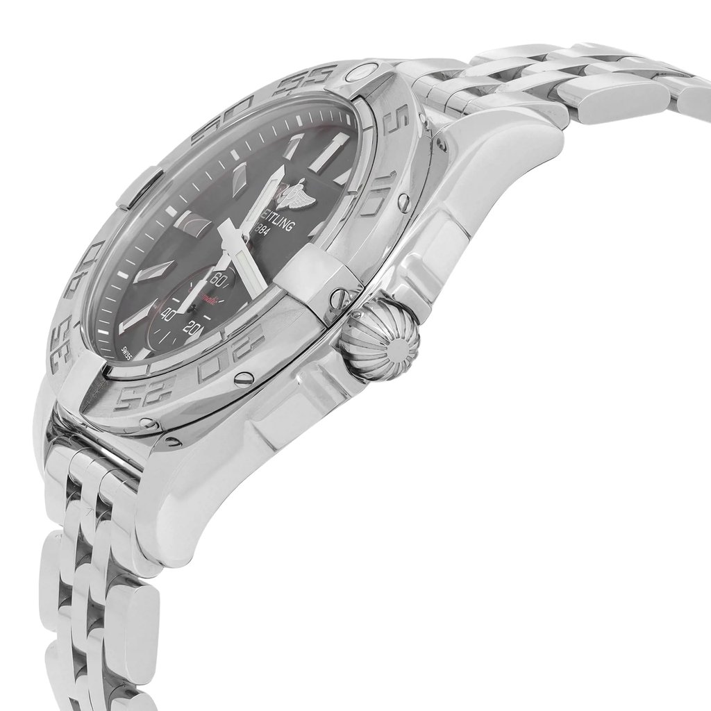 An image of a Breitling luxury unisex adult wristwatch, shown in a side profile view highlighting the crown. The watch features a round stainless steel case and band, a black dial, and a gray bezel. The image is a close-up, providing a clear view of the watch's details, including the texture on the crown and the sleek design of the band. The display model is positioned at an angle that accentuates its round shape and the reflective quality of the stainless steel. The watch is a display model and it may show minor blemishes due to store handling. 