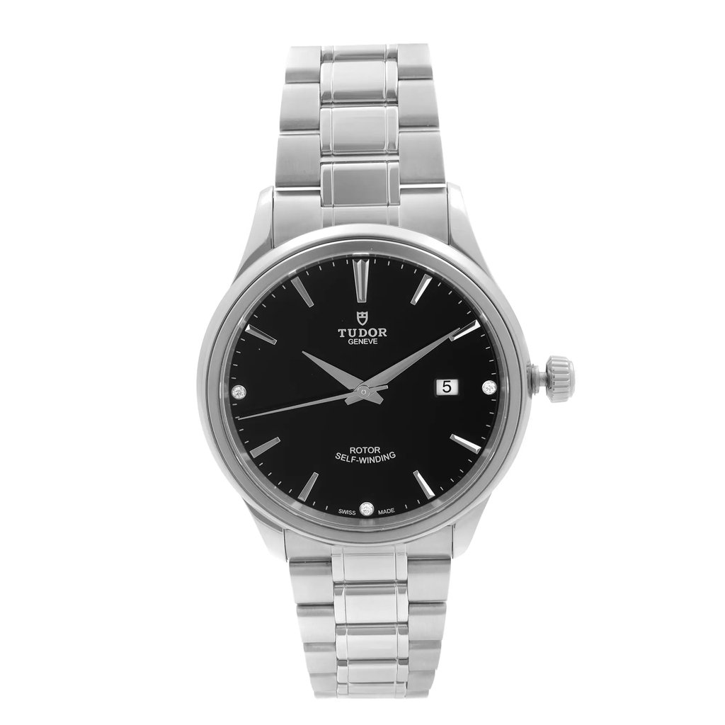 An image of a pre-owned Tudor Style men's wristwatch positioned vertically at a straight-on angle, displaying the full face and bracelet. The watch features a black diamond dial with a date indicator at the 3 o'clock position, set within a stainless steel case and bracelet. The photograph captures the watch from a close distance, highlighting its self-winding rotor functionality.