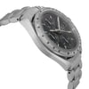 An image of a pre-owned wristwatch captured from a side profile view, opposite the crown. The watch features a stainless steel bracelet and case, with a detailed chronograph dial visible at an angle. The photograph is taken at close range, highlighting the sleek design and craftsmanship of the timepiece.
