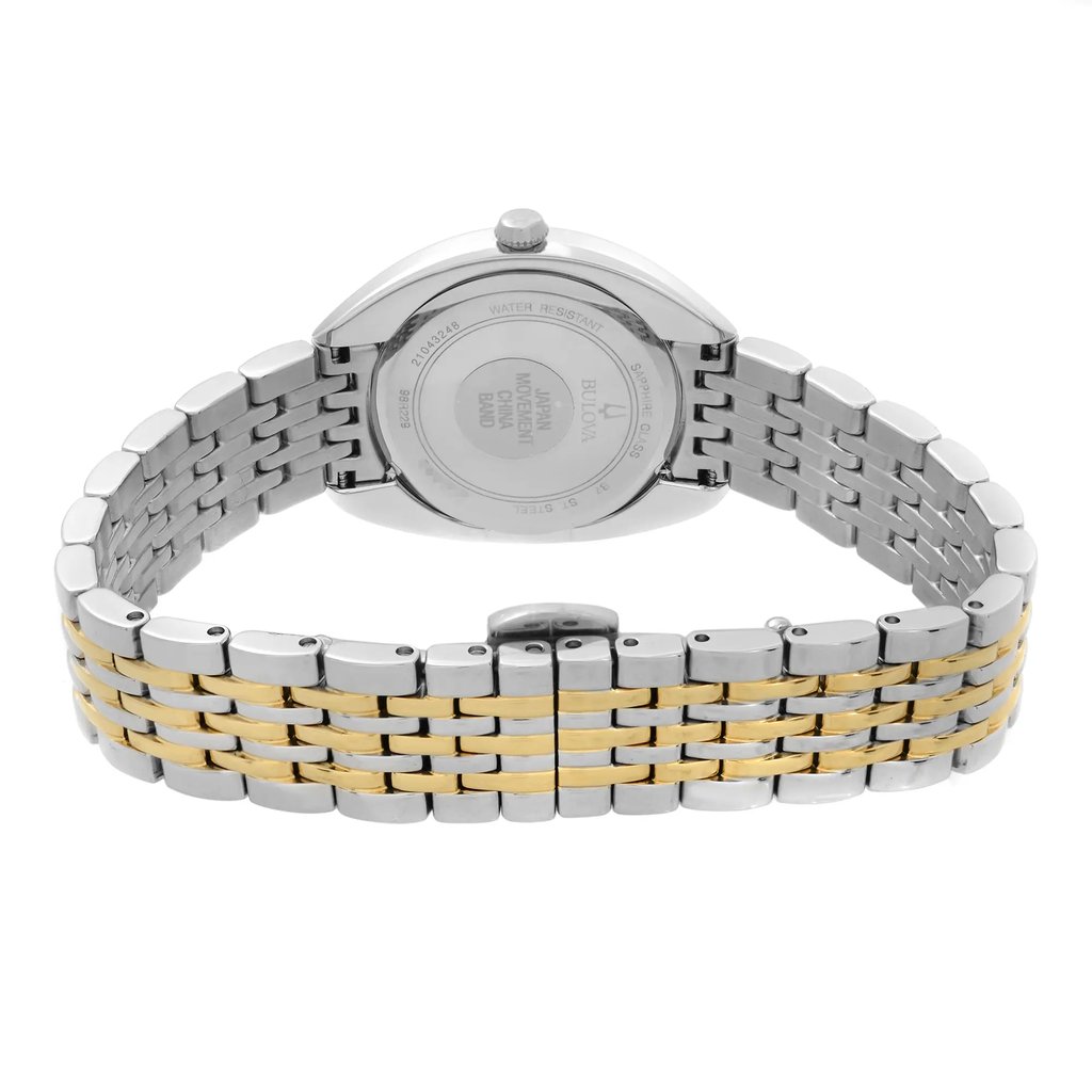 An image of a Bulova women's wristwatch, displaying the back view with the clasp closed. The watch features a round stainless steel case with a solid caseback and a two-tone stainless steel band with gold accents. The band is secured by a butterfly clasp. The watch is positioned upright with the clasp at the bottom, photographed from a straight-on angle at a close distance, highlighting the details of the band and the caseback engravings indicating water resistance and branding.