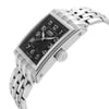 An image of a men's luxury Oris wristwatch in a side profile view, showcasing the crown prominently. The watch has a rectangular shape with a black dial and steel bezel. The band and case are made of stainless steel, emphasizing its sleek and elegant design. The watch is positioned at an angle that highlights the contours and details of the crown and band, captured from a close distance to emphasize the craftsmanship and quality.