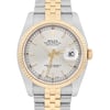 An image of a pre-owned men's Rolex wristwatch, showcasing a close-up frontal view. The watch features a two-tone metal band with gold and stainless steel links. The face is silver with gold hour markers and hands, which are luminous. The date indicator is prominently displayed on the right side of the dial. The watch is positioned upright, capturing its elegant design and intricate details.