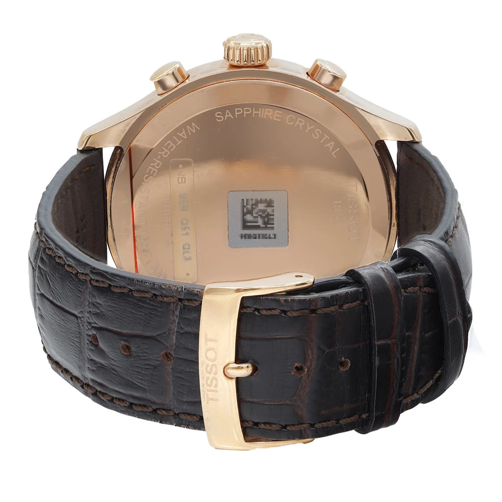 An image of a Wristwatch by Tissot. This Pre Owned item is designed for Men, featuring a Casual style. It has a Quartz movement and an Analog display with a Silver dial color. The indices include 12-Hour Dial,Stick Indexes. The band is made of Leather and the case is made of Stainless Steel. The watch has a Round shape with a case size of 45 mm and a case thickness of 11 mm.