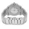 An image of a pre-owned Cartier men's wristwatch, viewed from the back at a slightly elevated angle. The focus is on the stainless steel bracelet and the transparent case back, showcasing the watch's intricate movement. The watch is positioned centrally and is captured from a close distance, highlighting details such as the blue cabochon crown and engraved text on the case.