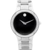 An image of a front close-up view of an unworn Movado women's wristwatch. The watch features a round black dial with a minimalist design, accented by a single dot at the 12 o'clock position and steel-colored hands. Surrounding the dial is a bezel adorned with diamonds, providing a formal appearance. The case and band are made of stainless steel, with the band visible in the foreground, leading into the watch face. The angle of the shot is head-on, focusing on the watch face with the band partially visible and tapering off into the distance. With "Swiss Movado Made" is inscribed at the bottom of the dial.