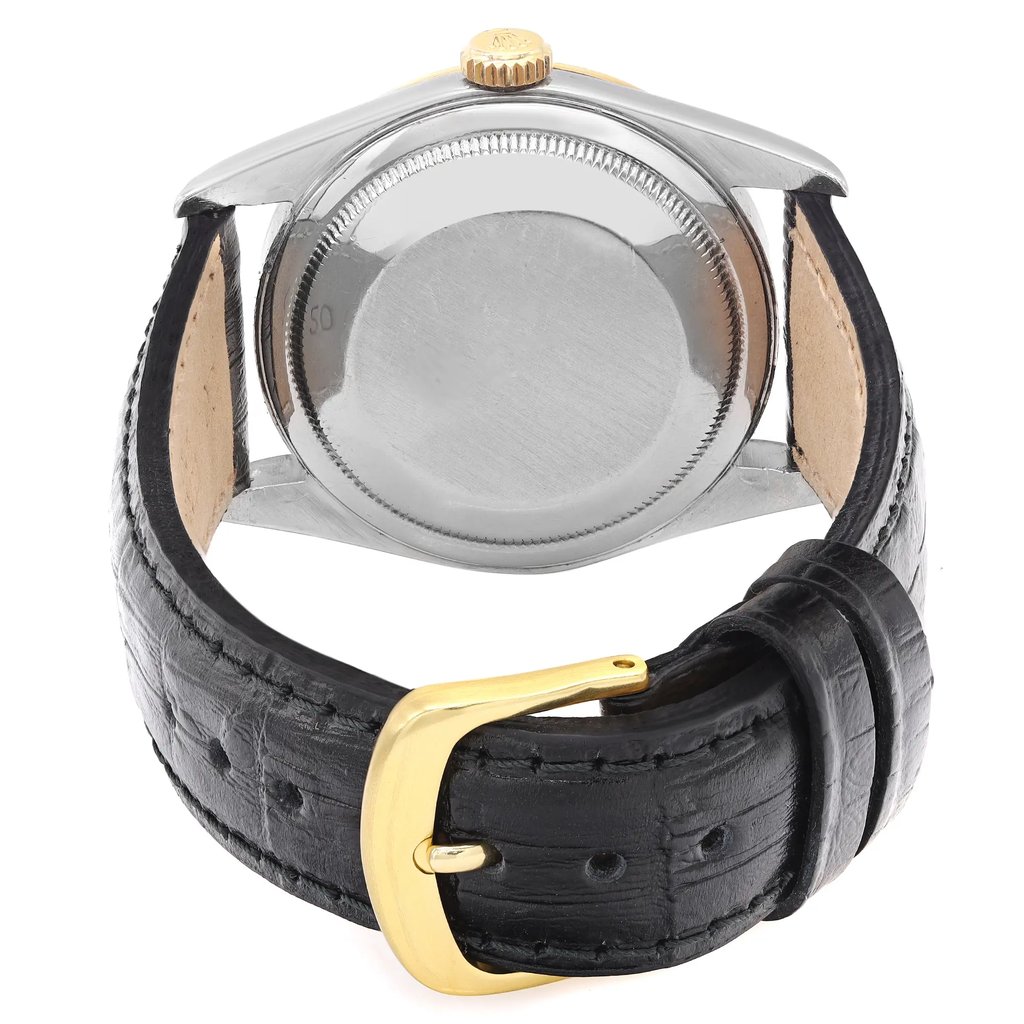 An image of a pre-owned men's Rolex wristwatch viewed from the back at a slight angle. The focus is on the stainless steel case back and the black leather strap with a gold buckle. The watch features a date indicator and luminous hands. The image is taken from a close distance, highlighting the details of the strap and buckle.